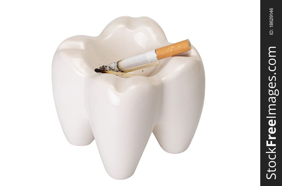 Ashtray in the form of a tooth with a stub on a white background