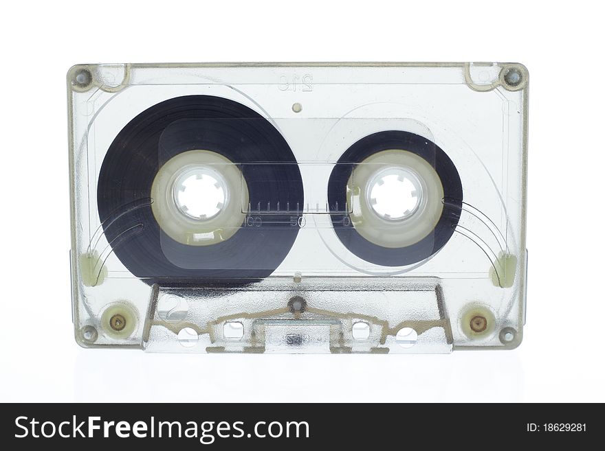 Old magnetic audio tape cassette isolated on white