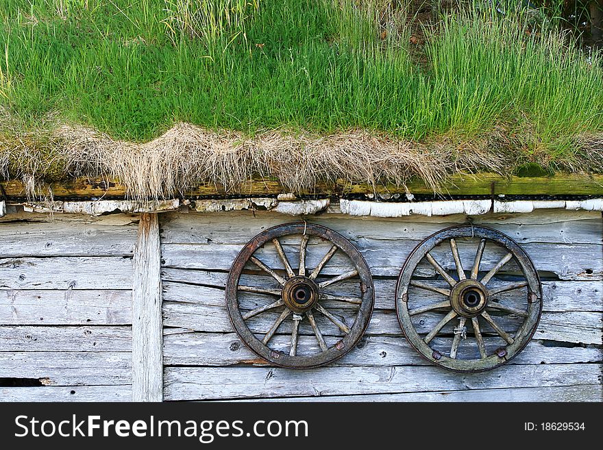 Spoked Wheels At A Wooden Hut