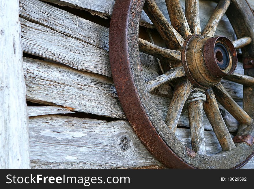 Spoked Old Wheel On A Wooden Wall