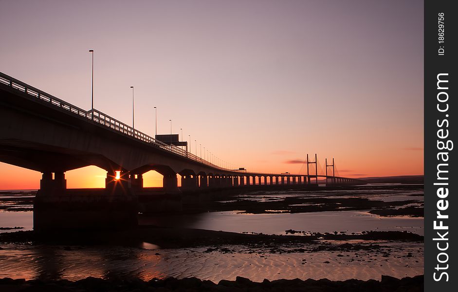 The sun goes down over the severn crossing between England and Wales. The sun goes down over the severn crossing between England and Wales