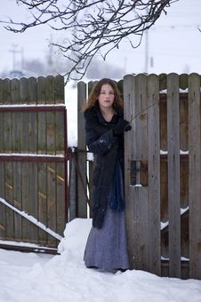 Young Girl In Long Dress Near Fence Royalty Free Stock Image Young Girl In Long Dress Near Fence Royalty Free Stock Image