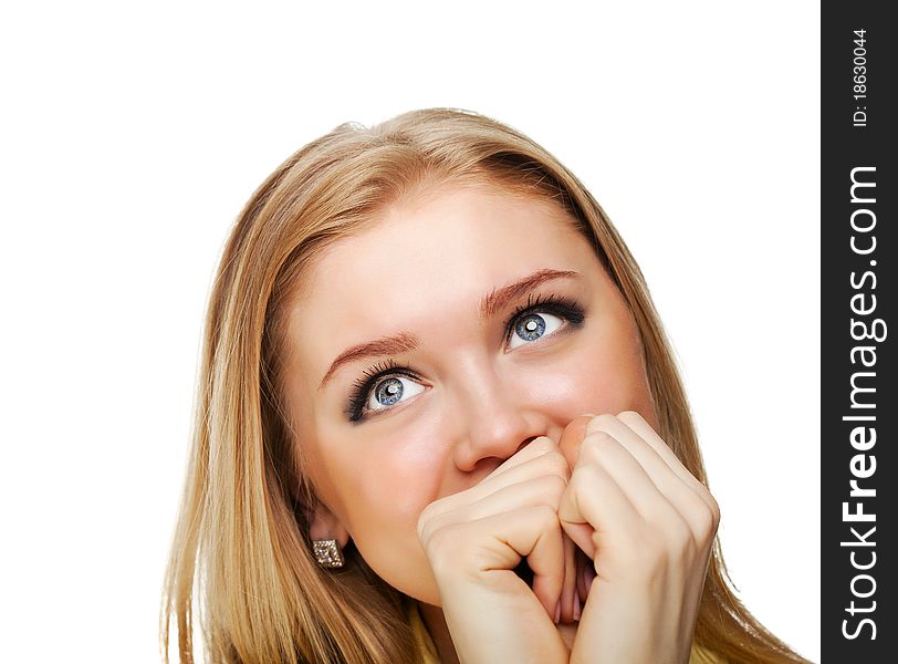 Portrait shot of a beautiful caucasian woman. Holding her face in astonishment.