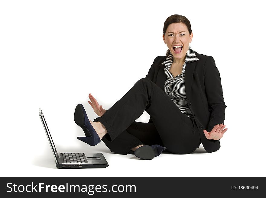 Pretty young businesswoman angry and kicking a laptop. Pretty young businesswoman angry and kicking a laptop