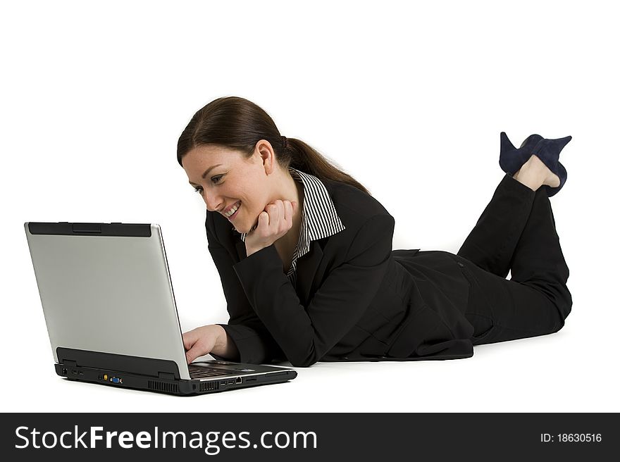 Portrait of a cute business woman lieing with a laptop isolated against white. Portrait of a cute business woman lieing with a laptop isolated against white
