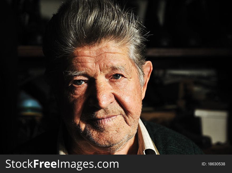 Elderly man in his workshop, portrait