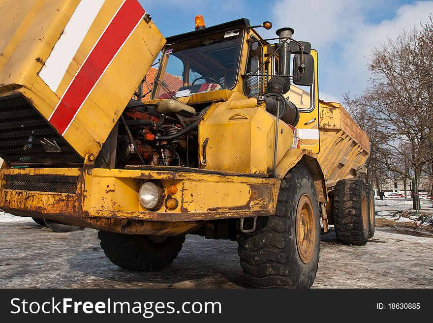 Big broken yellow dumper in a construction site