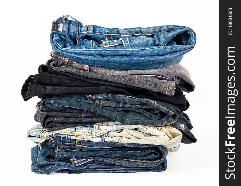 Stack of various jeans isolated on white