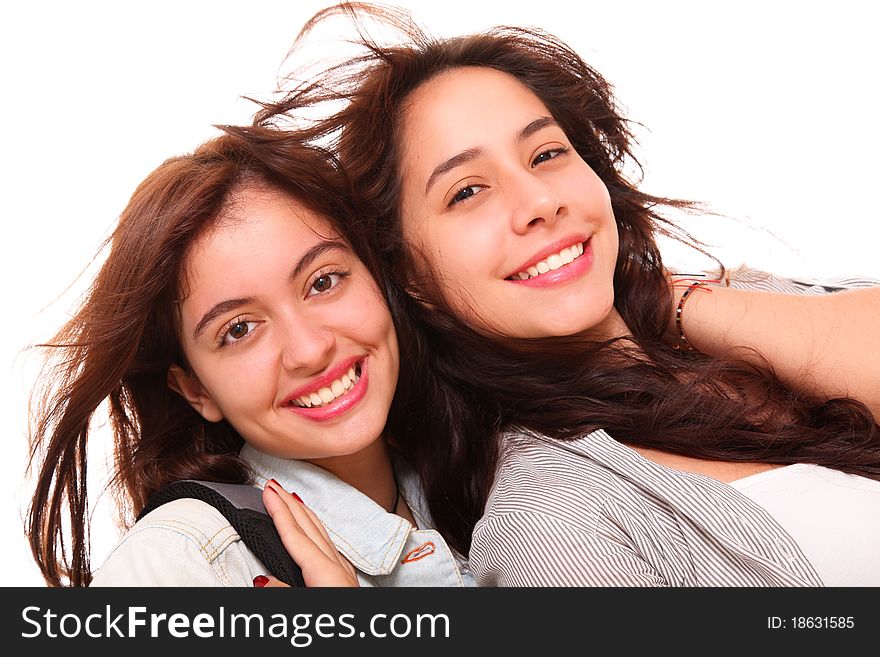 Two women smiling at the camera over white background