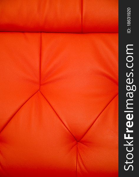 Stitchings on background of vertical red leather couch. Stitchings on background of vertical red leather couch