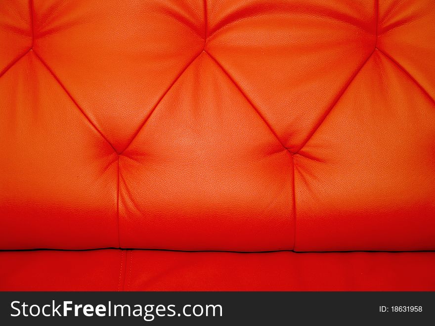 Stitchings on background of horizontal red leather couch. Stitchings on background of horizontal red leather couch