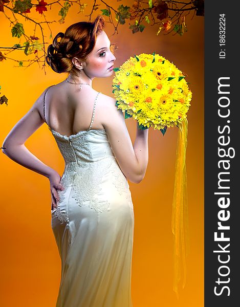 Gorgeous young redhead bride with bouquet of flowers. Gorgeous young redhead bride with bouquet of flowers