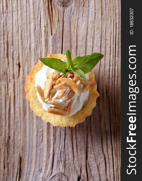 Tartlet pastry with cheese spread and roasted almonds. Tartlet pastry with cheese spread and roasted almonds