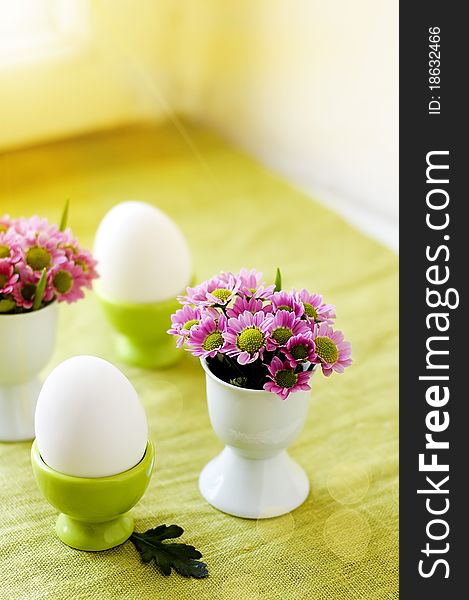 Easter eggs and flowers in an egg cups