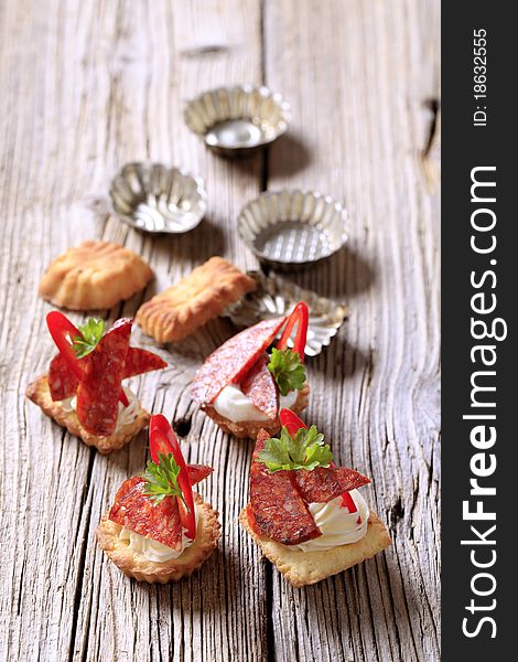 Tartlet based canapes with pieces of spicy salami. Tartlet based canapes with pieces of spicy salami