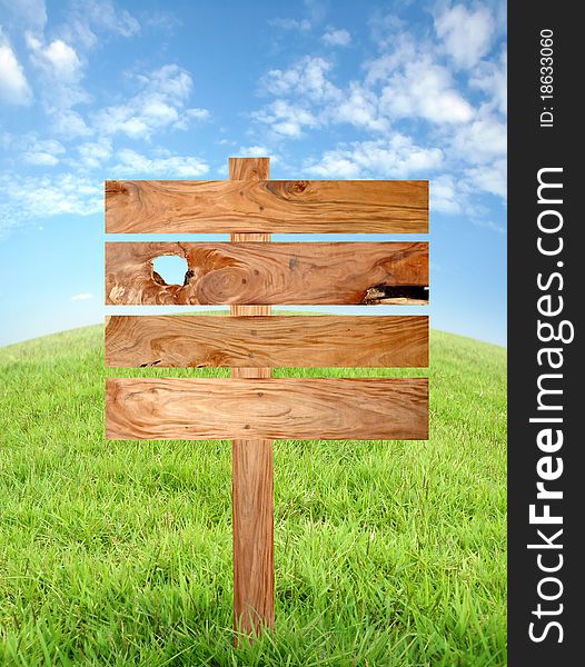 Wooden signboard with meadow and blue sky