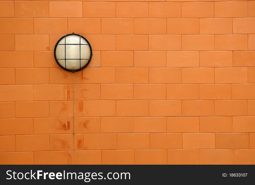 Round lamp on orange brickwall. Round lamp on orange brickwall