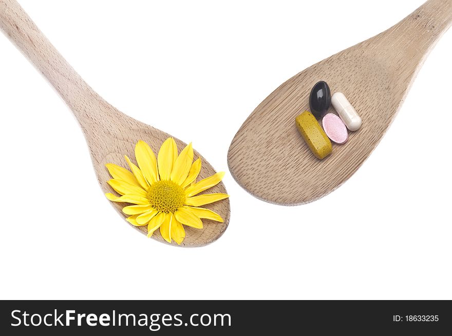 Natural Medicine Concept with Spoons Full of Flowers and Vitamins. Natural Medicine Concept with Spoons Full of Flowers and Vitamins.