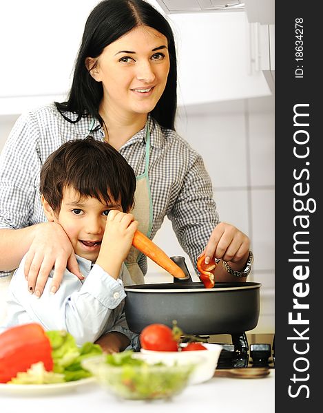 Happy mother and little son in the kitchen, happy time and togetherness