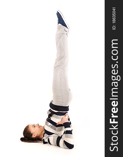 Beautiful young woman makes stretching isolated over white background