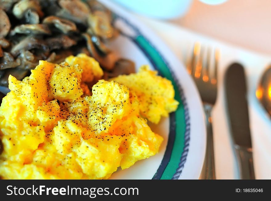 Western meal of scrambled egg and mushroom.