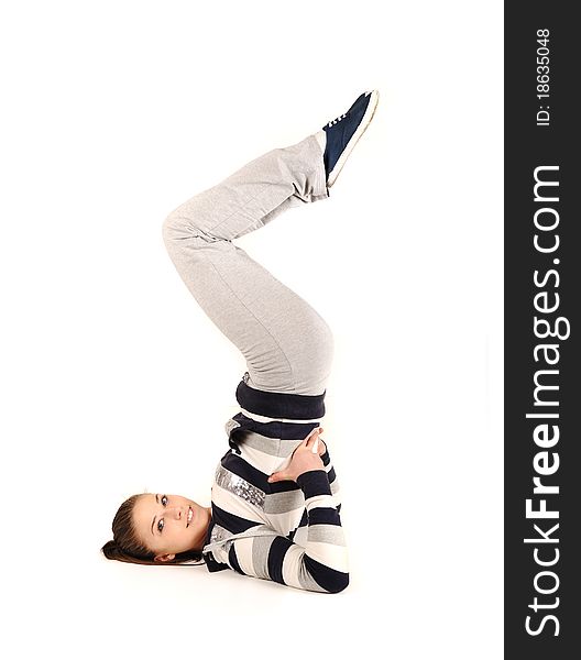 Beautiful young woman makes stretching isolated over white background