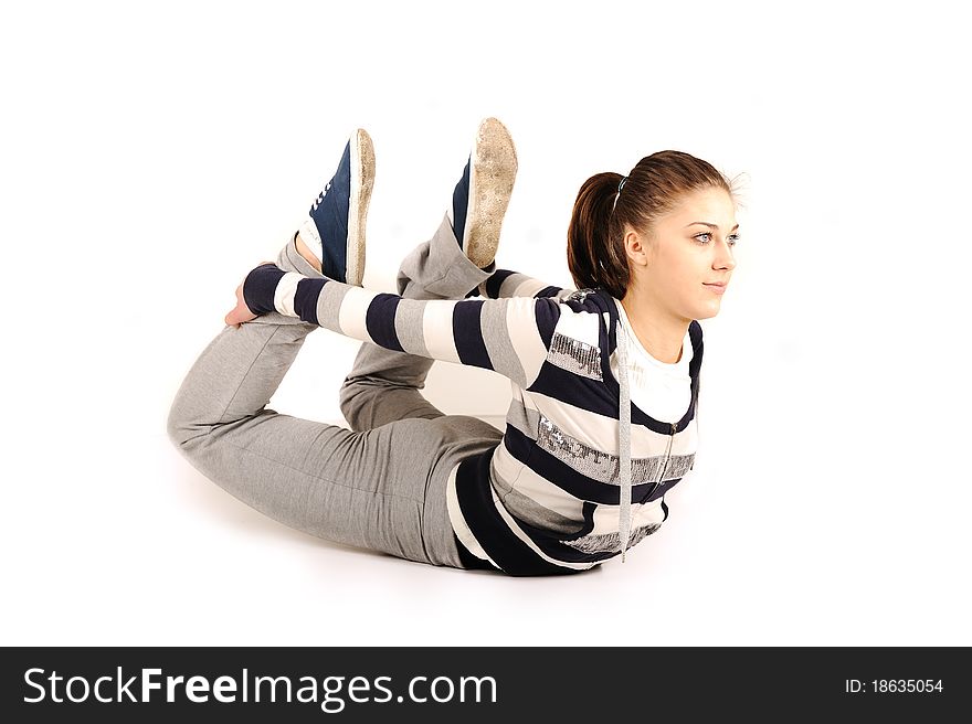 Beautiful young woman makes stretching isolated over white background