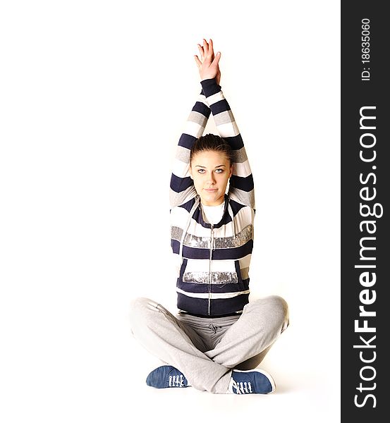 Beautiful young woman makes stretching isolated over white background