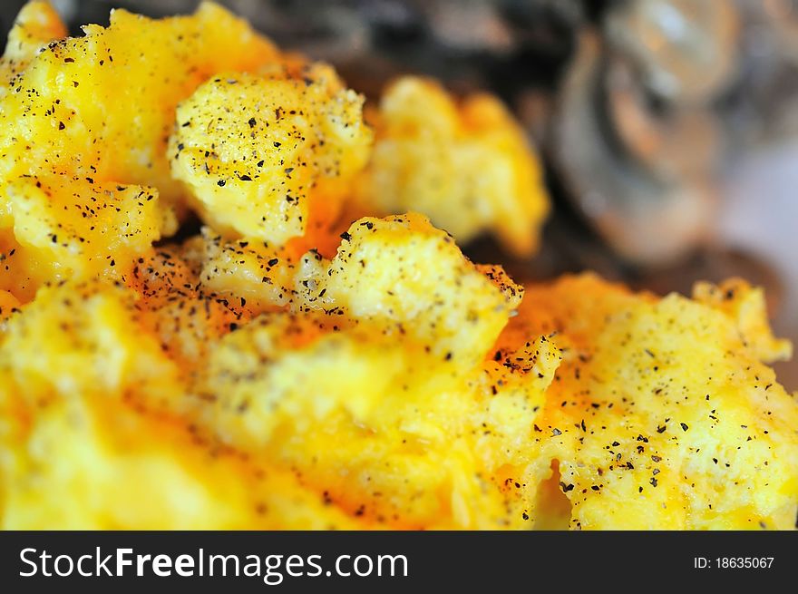 Macro of scrambled egg topped with spices.