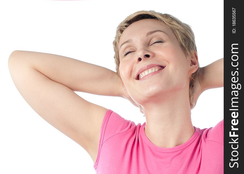 Beautiful short haired blonde woman relaxing and smiling with her hands behind her head. Isolated on white background. Beautiful short haired blonde woman relaxing and smiling with her hands behind her head. Isolated on white background