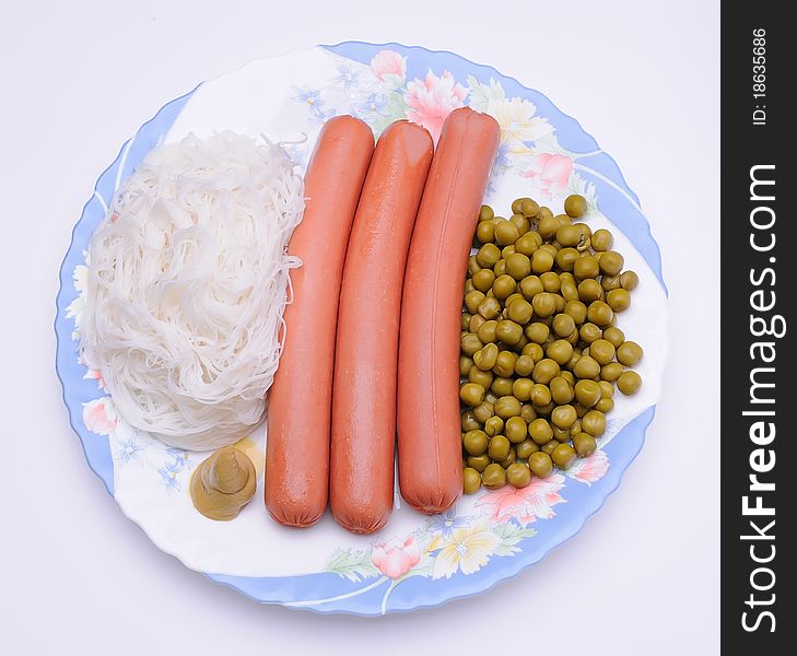 Dish with sausage, noodles and green peas. Dish with sausage, noodles and green peas