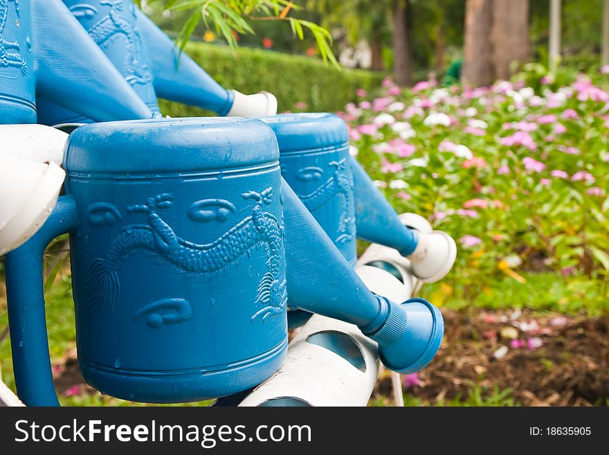 Blue watering pot in the garden
