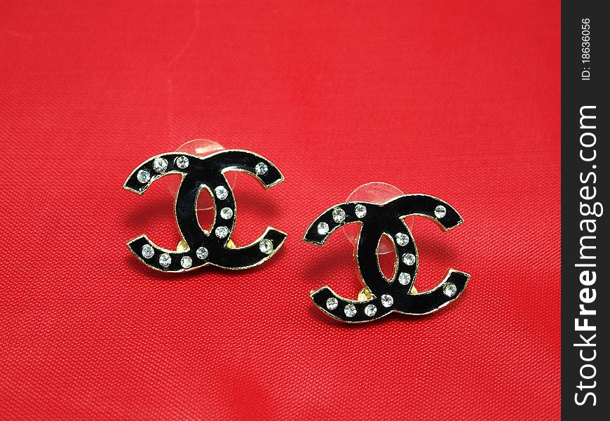 Black Earrings With Isolated On Red