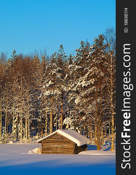 Old barn in snowy field. Old barn in snowy field.