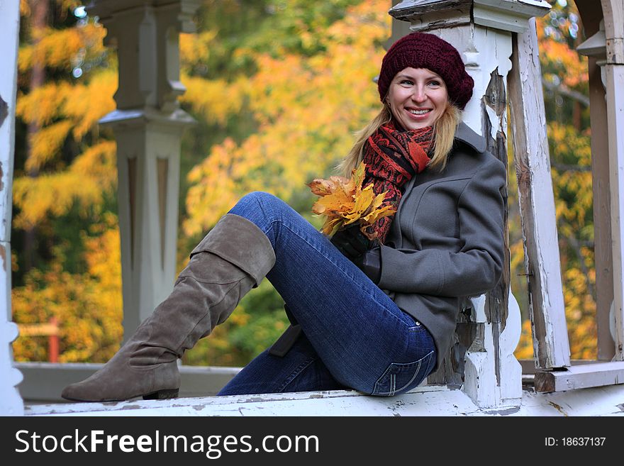 Beautiful young woman is enjoying the atmosphere of colorful autumn in Finland. Beautiful young woman is enjoying the atmosphere of colorful autumn in Finland.