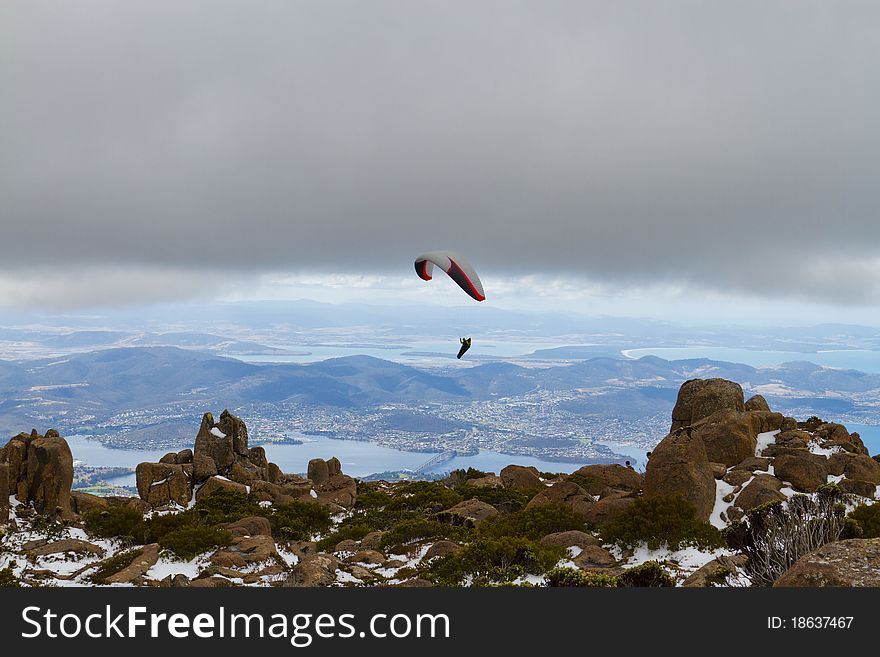 A paraglider gliding over the beautiful Mount Wellington, Tasmania. A paraglider gliding over the beautiful Mount Wellington, Tasmania.
