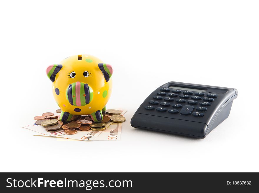 A piggy bank with money and a calculator on white background. A piggy bank with money and a calculator on white background