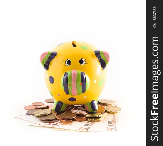 A piggy bank standing on money on white background. A piggy bank standing on money on white background