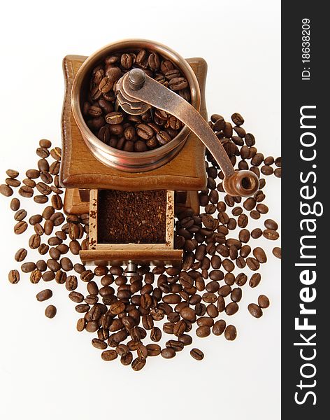 Coffee mill with roasted beans from above on the white background