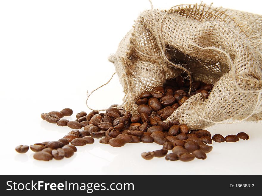 Burlap sack of roasted beans on the white background