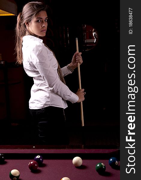 Detail view of a girl next to a snooker table. Detail view of a girl next to a snooker table.