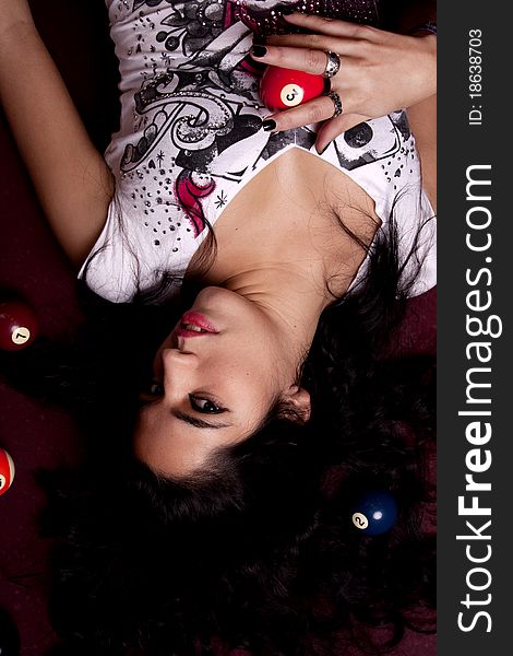 Detail view of a girl next to a snooker table. Detail view of a girl next to a snooker table.