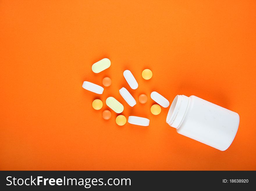 Pills on orange backgroun