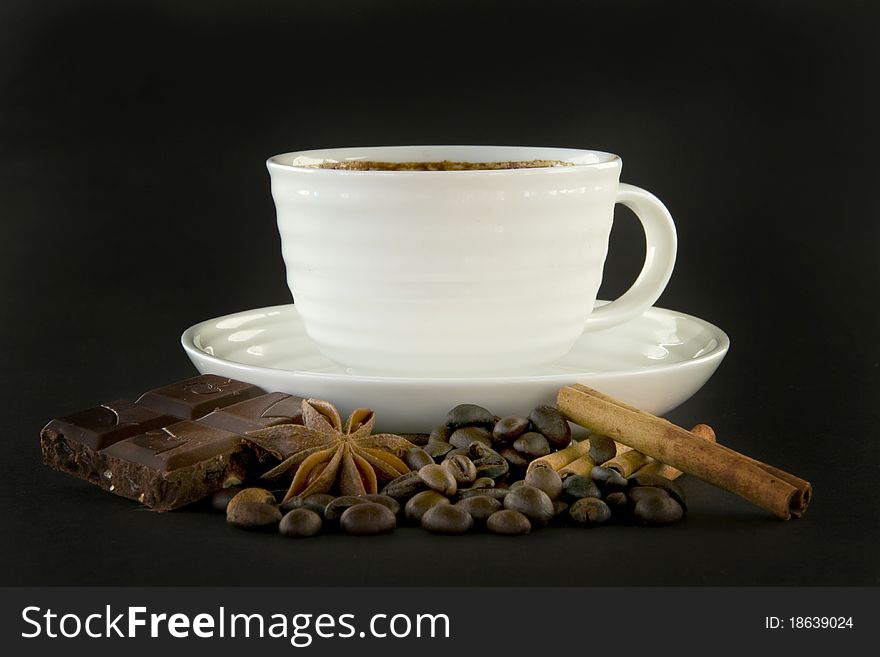 Cup of coffee and spice on black background. Cup of coffee and spice on black background.