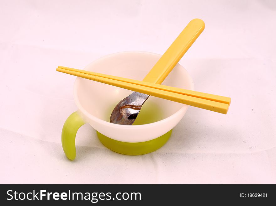 A set of child's tableware with bowl spoon and chopstricks.