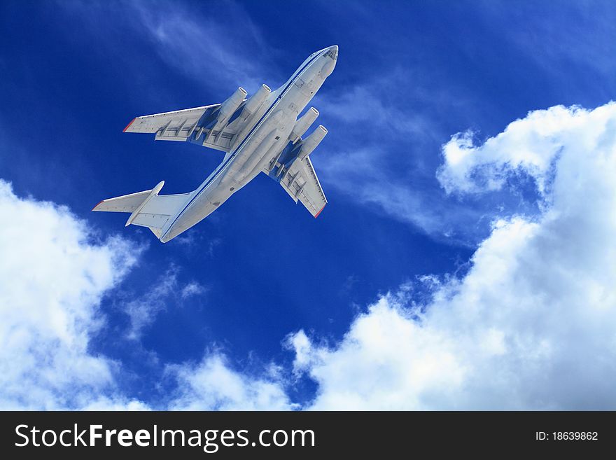 Passenger airplane flying in blue sky with clouds