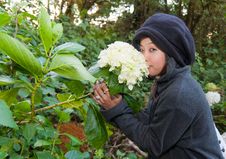 Young Woman Smelling Flower Stock Photography