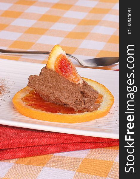 Chocolate mouse and orange served over a white plate. Chocolate mouse and orange served over a white plate.