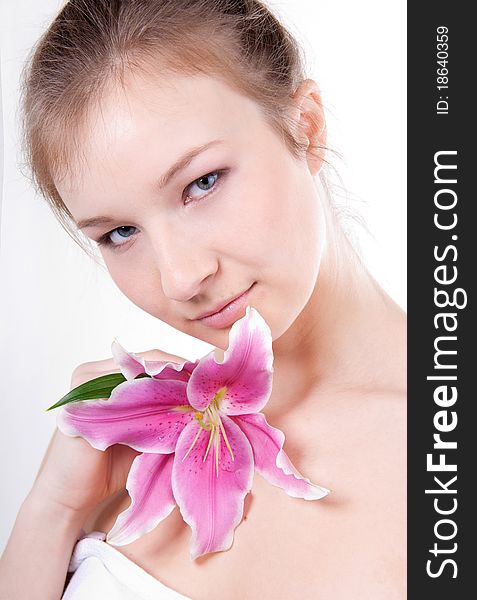 Close-up studio portrait of beautiful young woman with lily flower. Close-up studio portrait of beautiful young woman with lily flower