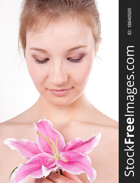 Close-up studio portrait of beautiful young woman with lily flower. Close-up studio portrait of beautiful young woman with lily flower